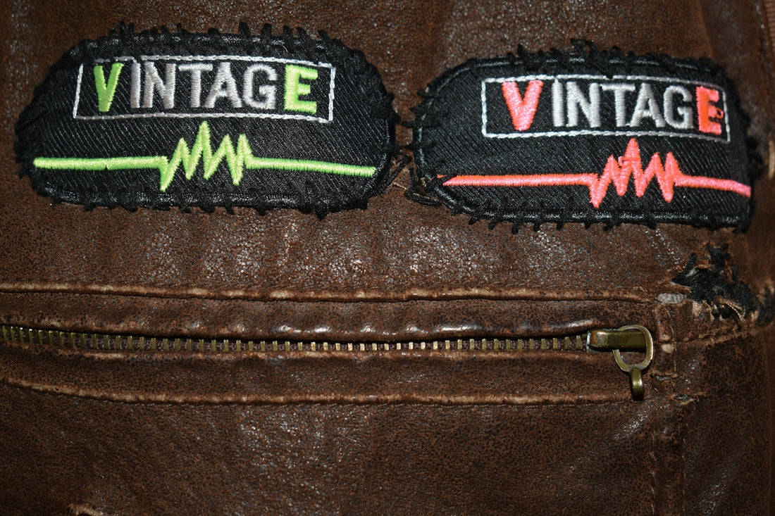 Two vintage patches on a brown leather jacket
